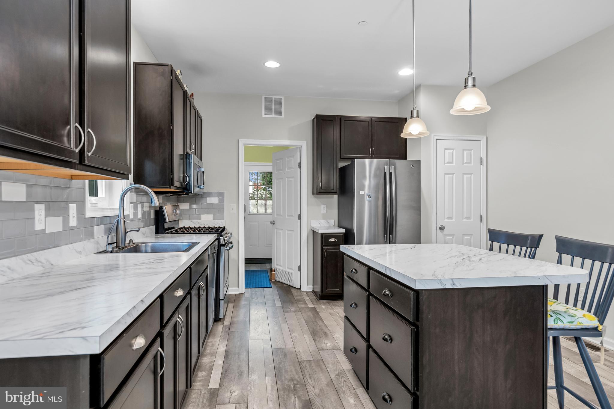 5440 Anchor Road Tilghman, MD 21671 - Photo 14 of 32 a kitchen with stainless steel appliances granite countertop a sink a stove and a refrigerator