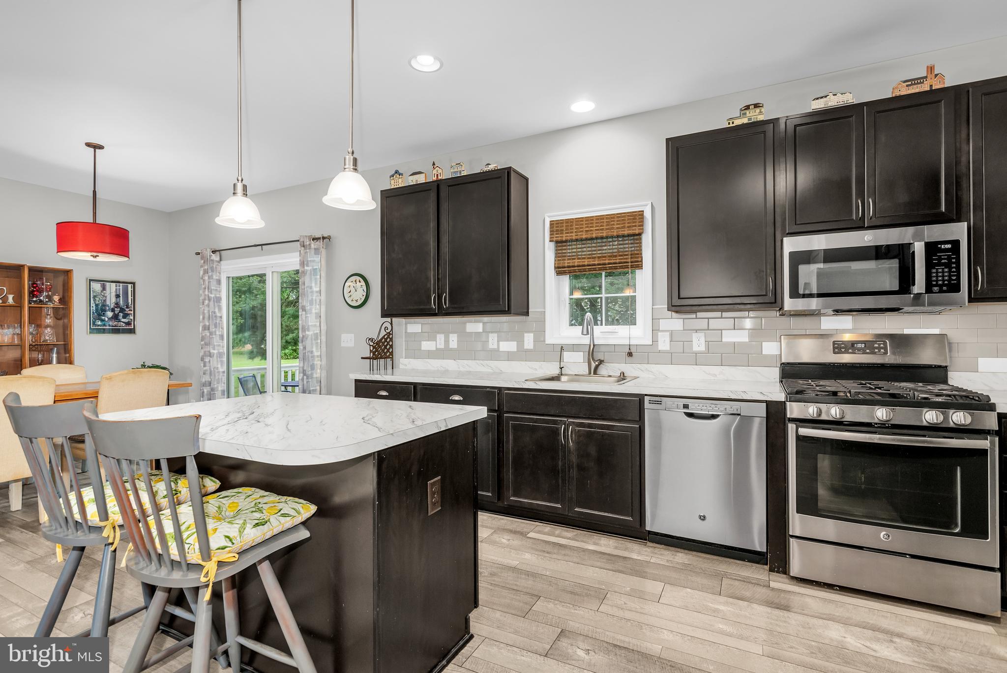 5440 Anchor Road Tilghman, MD 21671 - Photo 17 of 32 a kitchen with stainless steel appliances granite countertop a stove a sink and a microwave