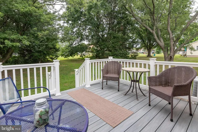 a view of a chairs and table on the wooden deck