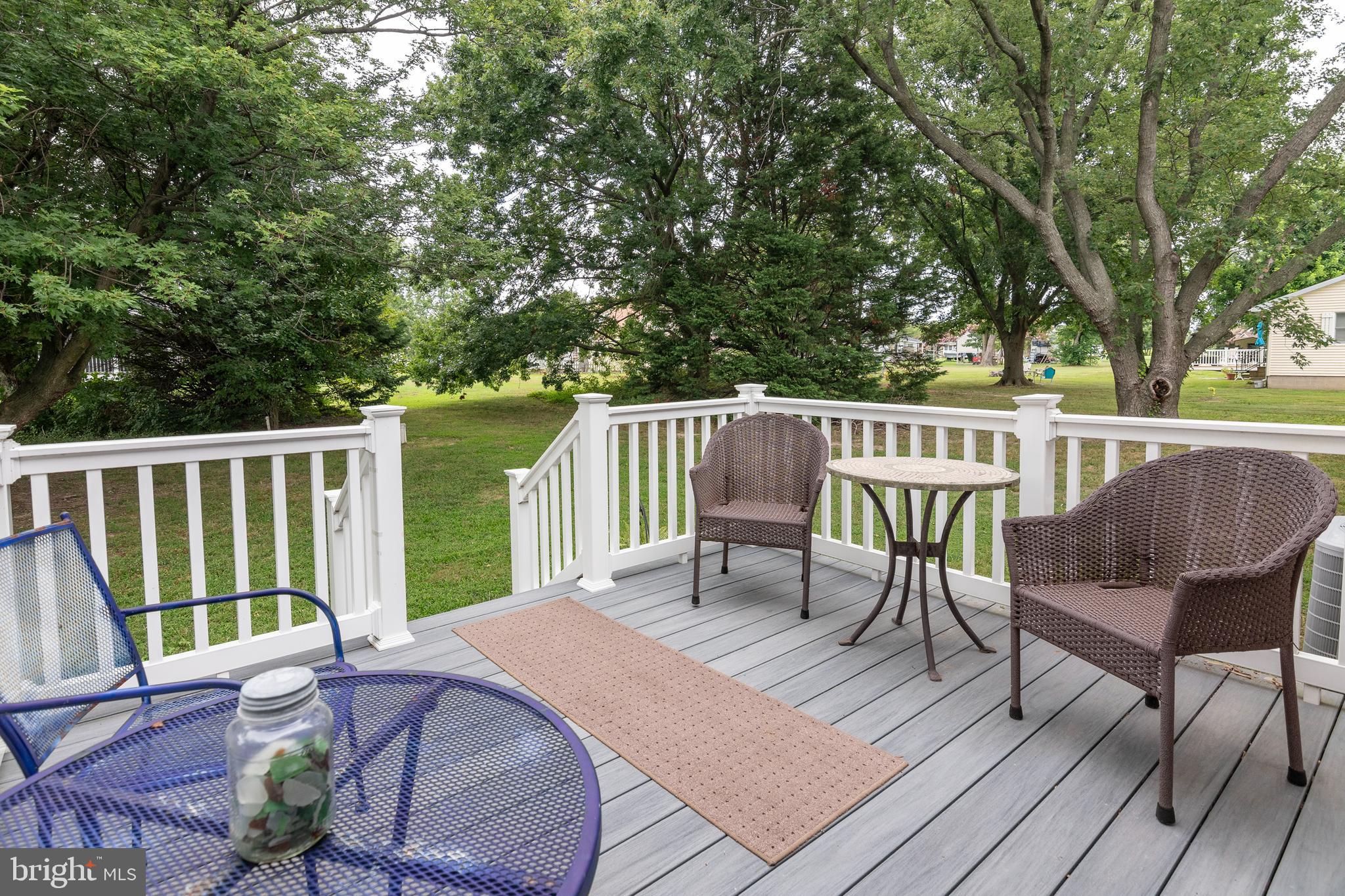 5440 Anchor Road Tilghman, MD 21671 - Photo 27 of 32 a view of a chairs and table on the wooden deck