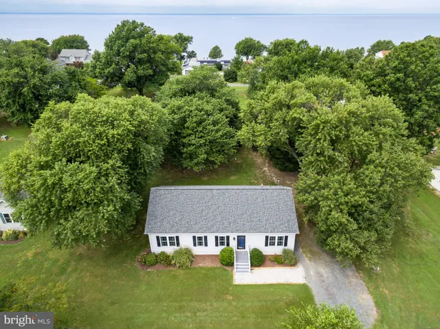 an aerial view of a house with swimming pool and garden