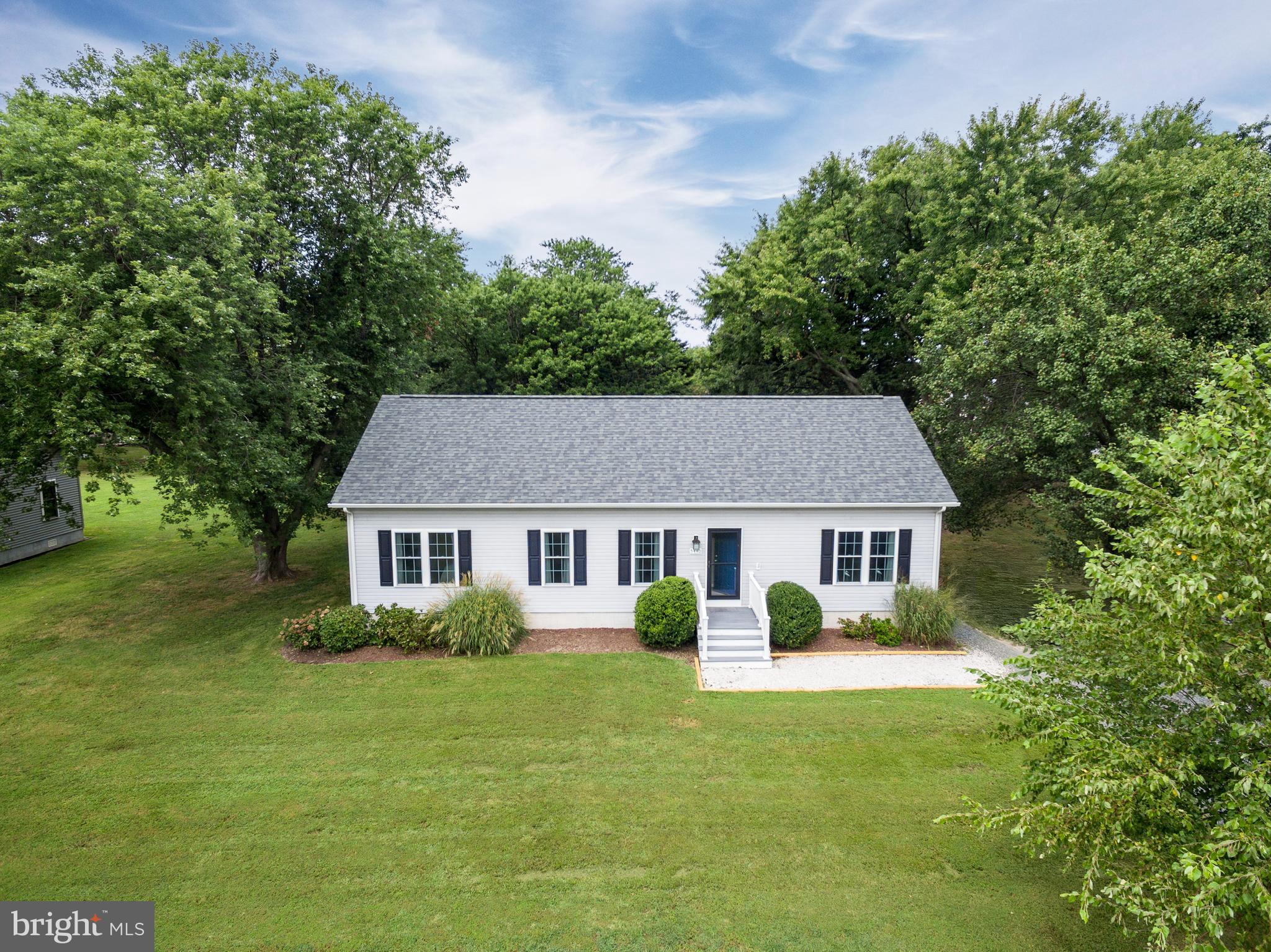 5440 Anchor Road Tilghman, MD 21671 - Photo 9 of 32 a view of house with a big yard and large trees