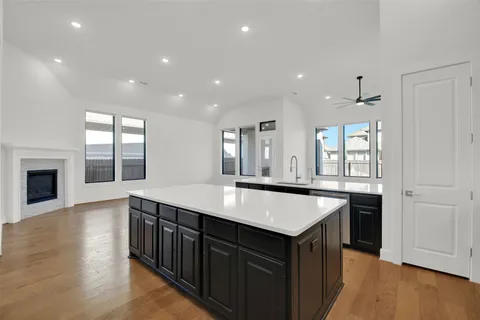 a view of an empty room with cabinet and a window
