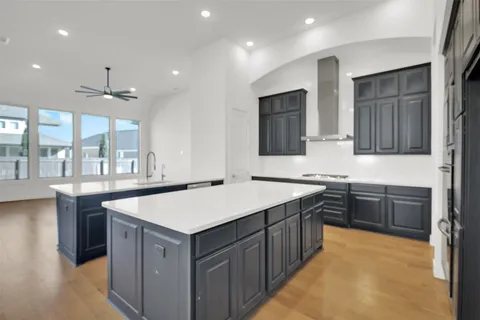 a kitchen with a sink a counter top space stainless steel appliances and cabinets