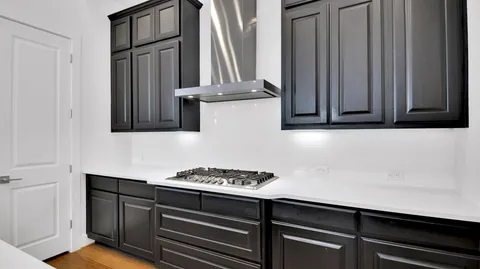 a kitchen with a sink stove and cabinets