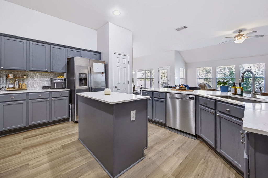 400 Ranier Lane Round Rock, TX 78665 - Photo 35 of 36 An open floor plan connects the modern kitchen with vaulted ceilings to adjacent living spaces.