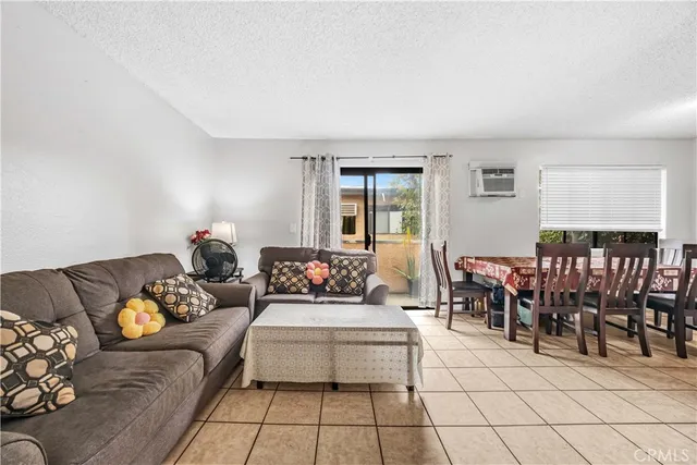 a living room with furniture and a dining table