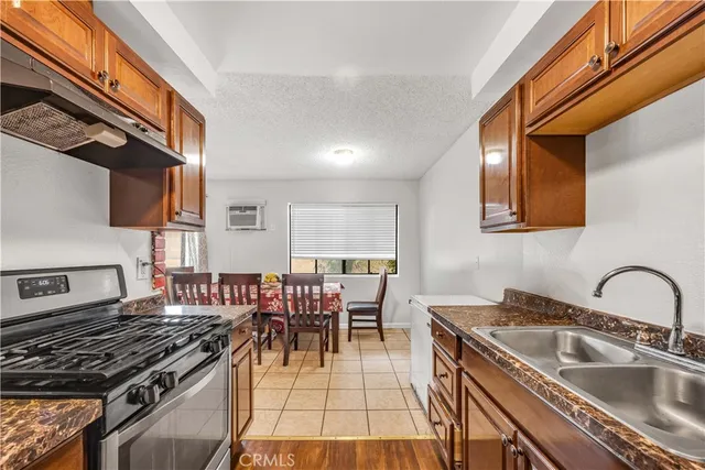a kitchen with a stove a sink and cabinets