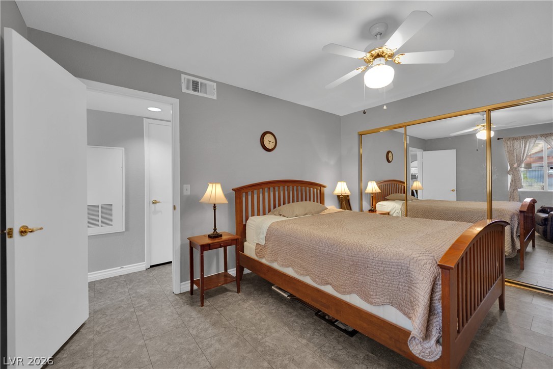 7570 West Flamingo Road, Unit 115 Las Vegas, NV 89147 - Photo 21 of 34 Relax in this tranquil bedroom, offering ample light and convenient closet space.