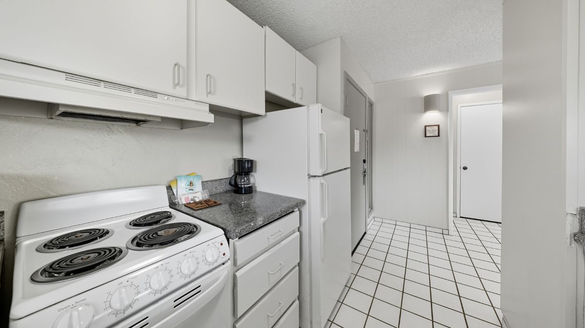 525 Aleka Loop, Unit A12 Kapaa, HI 96746 - Photo 11 of 20 a kitchen with white cabinets and white appliances
