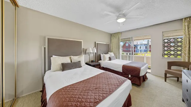 a bedroom with a bed a couch and a large window