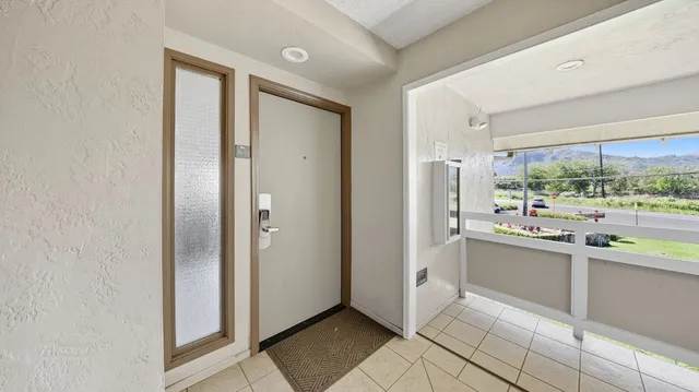 a large kitchen with a window and stainless steel appliances