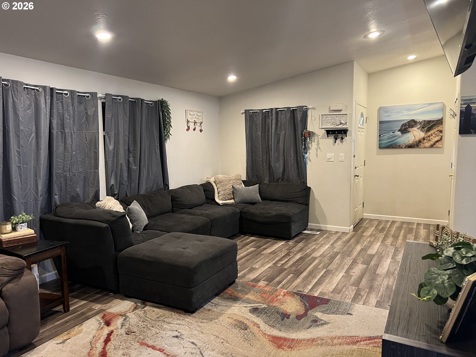 210 Northwest Grinstead Street Siletz, OR 97380 - Photo 8 of 29 a living room with furniture and a refrigerator