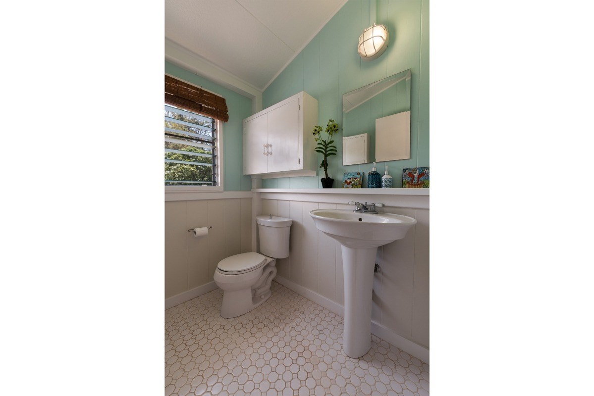 4472 A Panako Road Waimea, HI 96796 - Photo 10 of 25 a bathroom with a toilet a sink and mirror