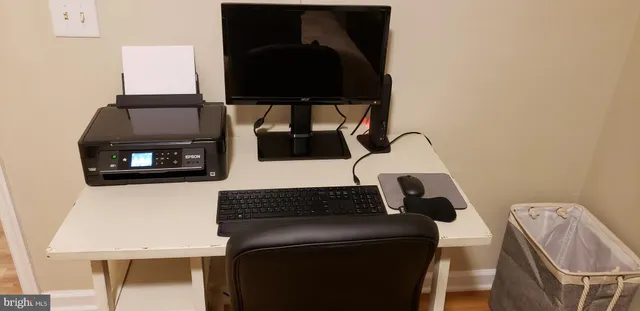 a bathroom with a granite countertop toilet sink and mirror