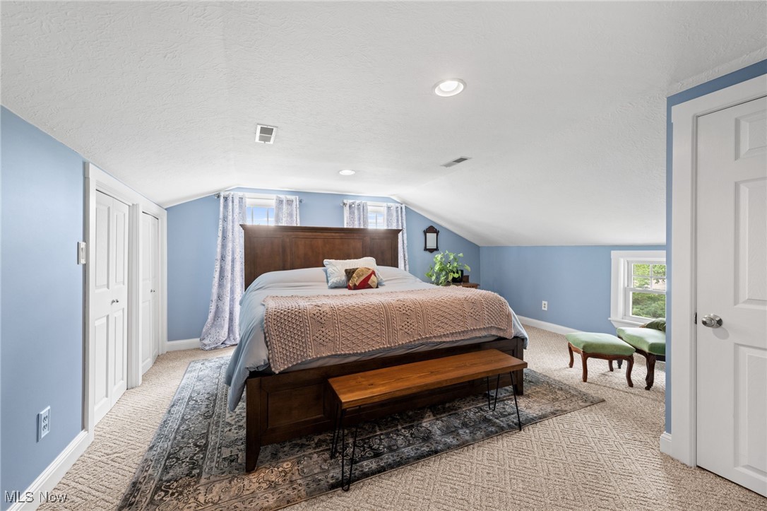 3945 Columbia Road Medina, OH 44256 - Photo 20 of 40 Bedroom featuring light colored carpet, a textured ceiling, recessed lighting, and lofted ceiling