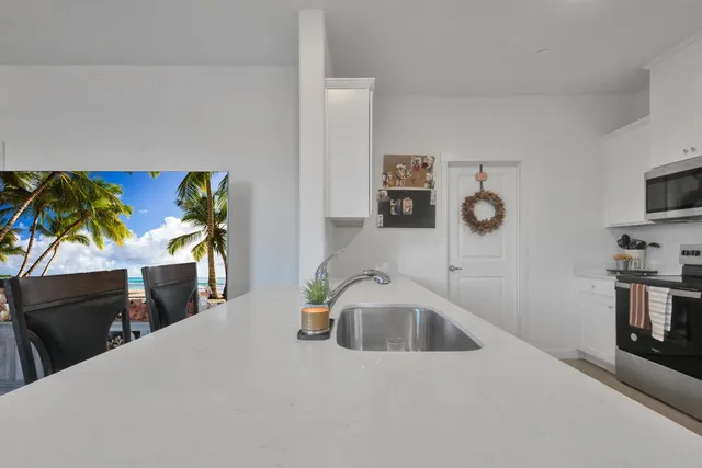 a kitchen with stainless steel appliances a sink a stove and a refrigerator