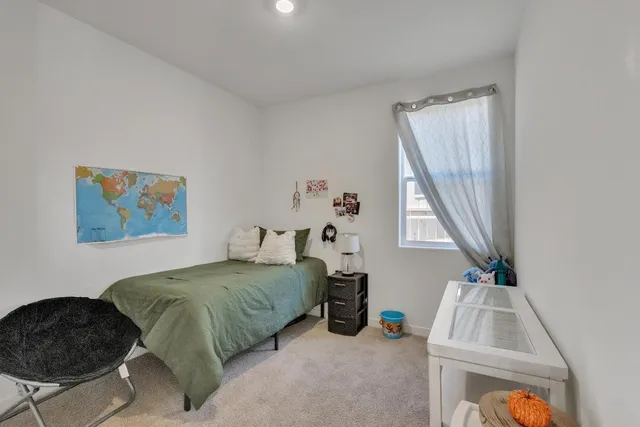 a bedroom with a bed and a window