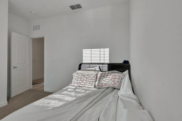 a bedroom with a bed and a dresser