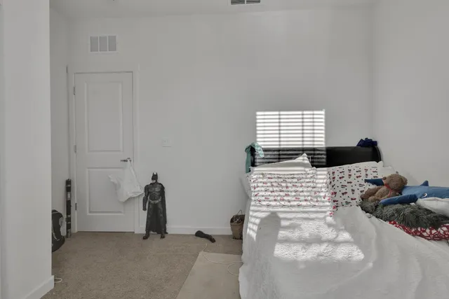 a bed sitting in a bedroom next to a window