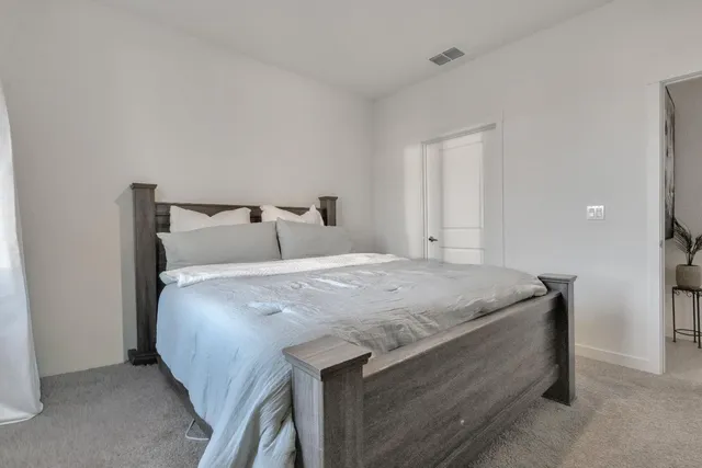 a bed sitting in a bedroom next to a window