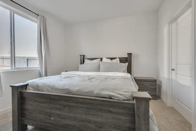 a bedroom with a bed and with furniture