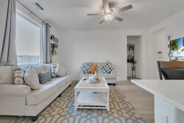 a living room with furniture and a chandelier