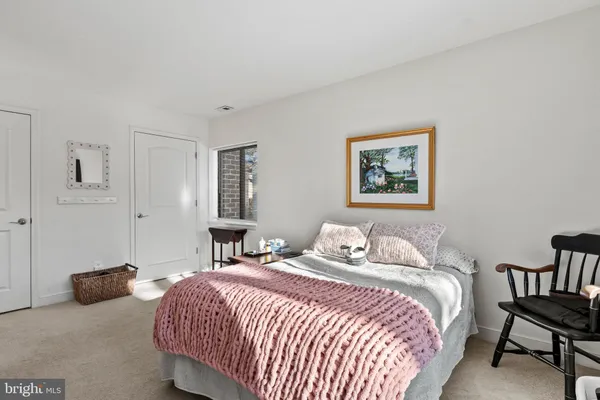 a bedroom with a bed and a lamp with window