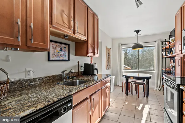 a kitchen with stainless steel appliances granite countertop a stove and a sink