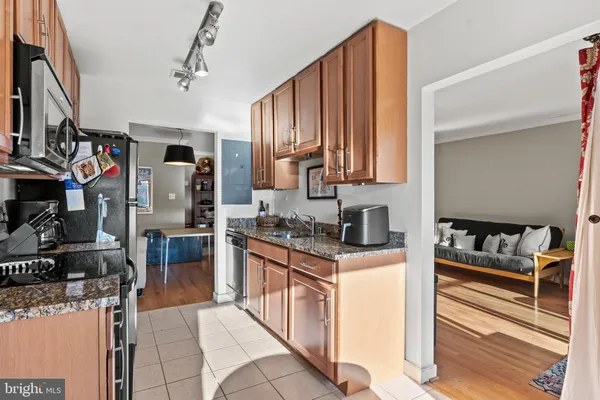a kitchen with stainless steel appliances granite countertop a stove a refrigerator and a sink