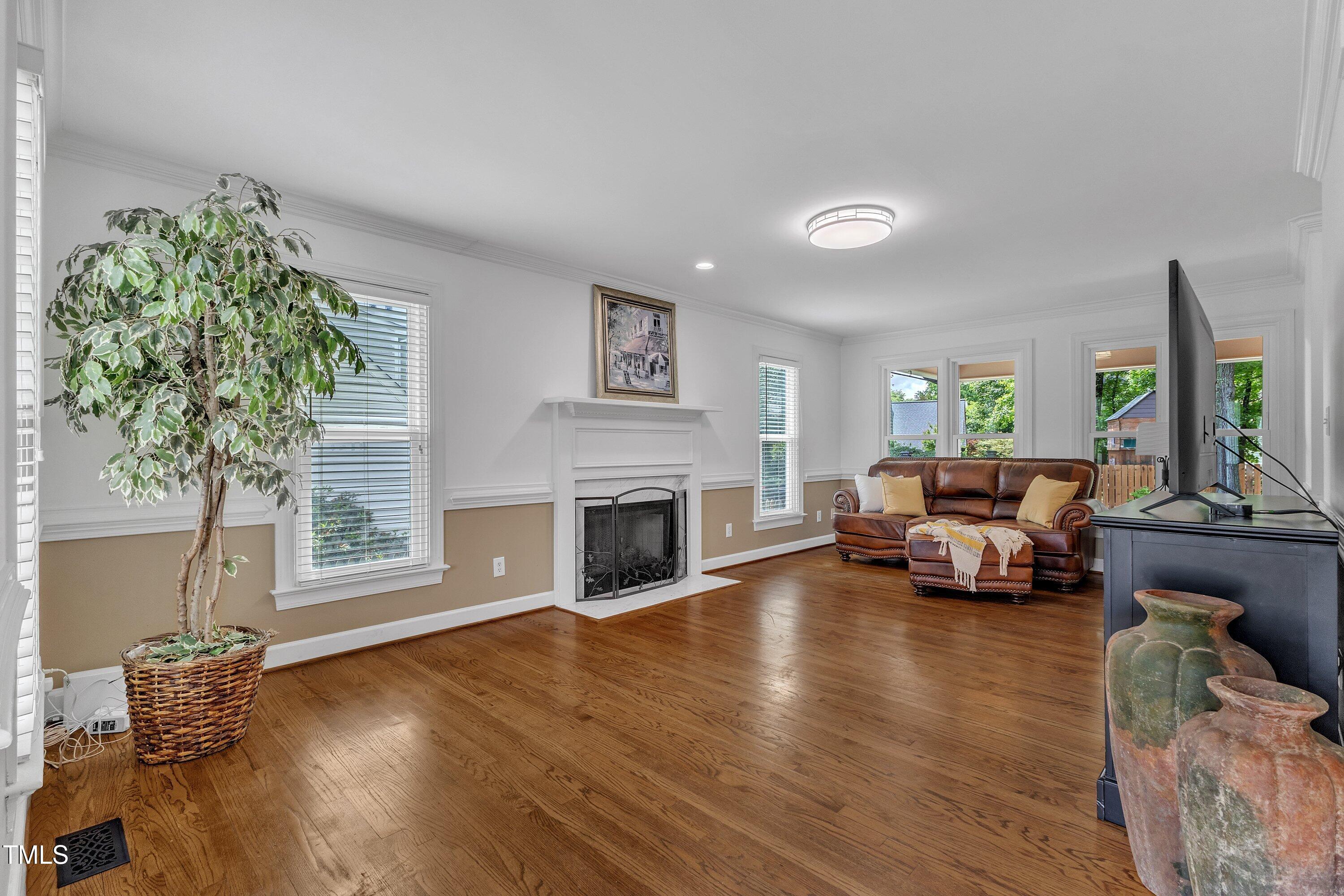 2721 Dahlgreen Road Raleigh, NC 27615 - Photo 9 of 59 a living room with furniture large window and a fireplace