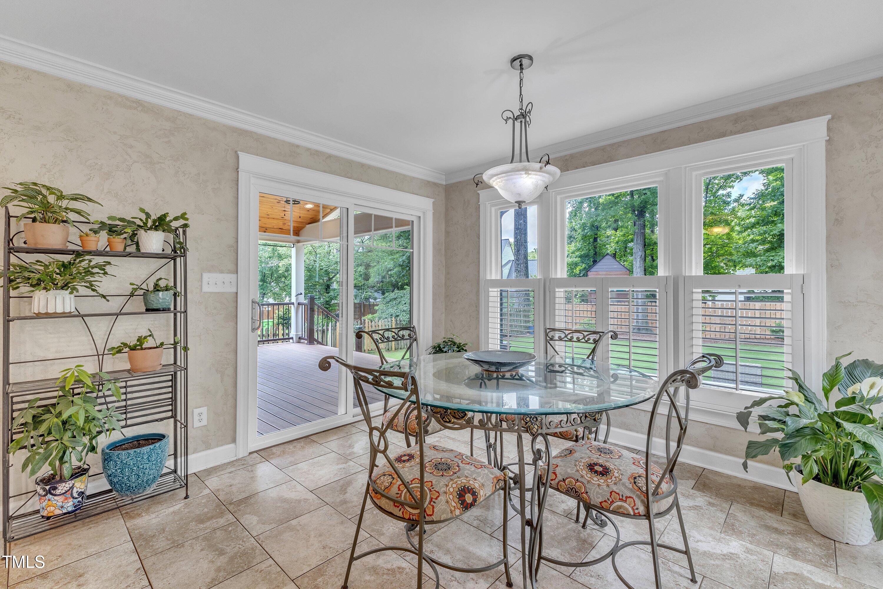 2721 Dahlgreen Road Raleigh, NC 27615 - Photo 22 of 59 a dining room with furniture wooden floor and a chandelier