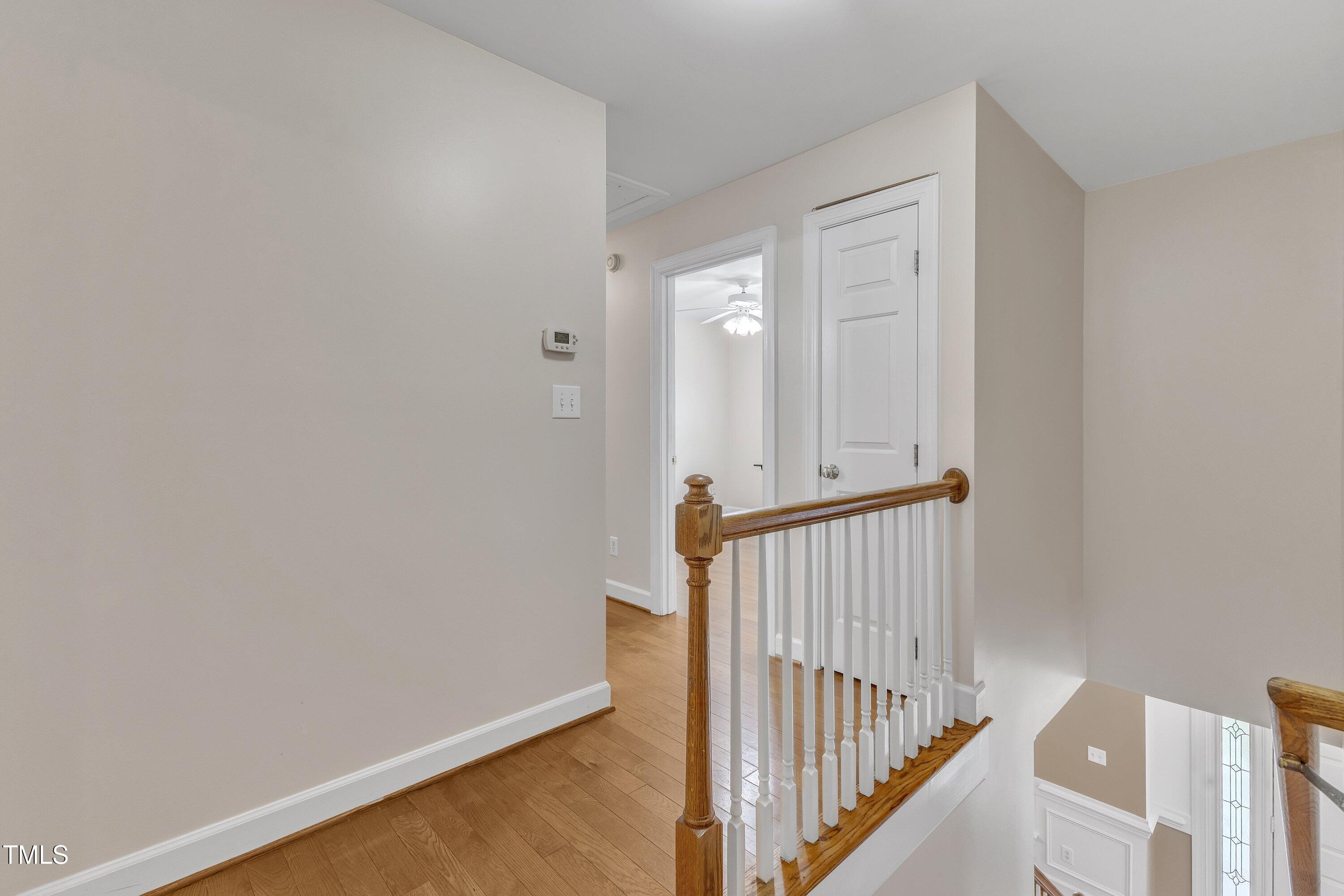 2721 Dahlgreen Road Raleigh, NC 27615 - Photo 24 of 59 a view of a hallway with wooden floor and staircase