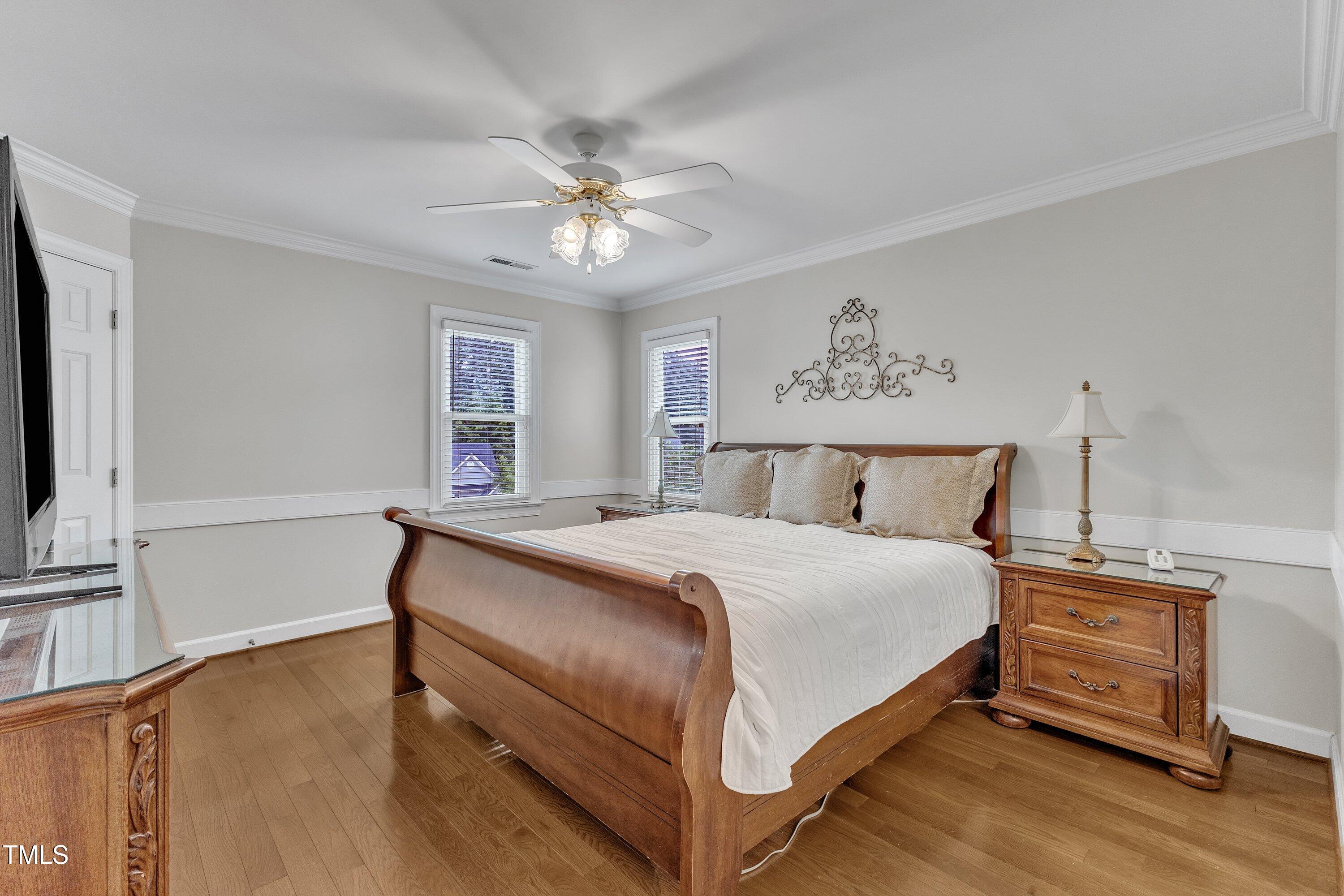 2721 Dahlgreen Road Raleigh, NC 27615 - Photo 25 of 59 a bedroom with a bed and a chandelier