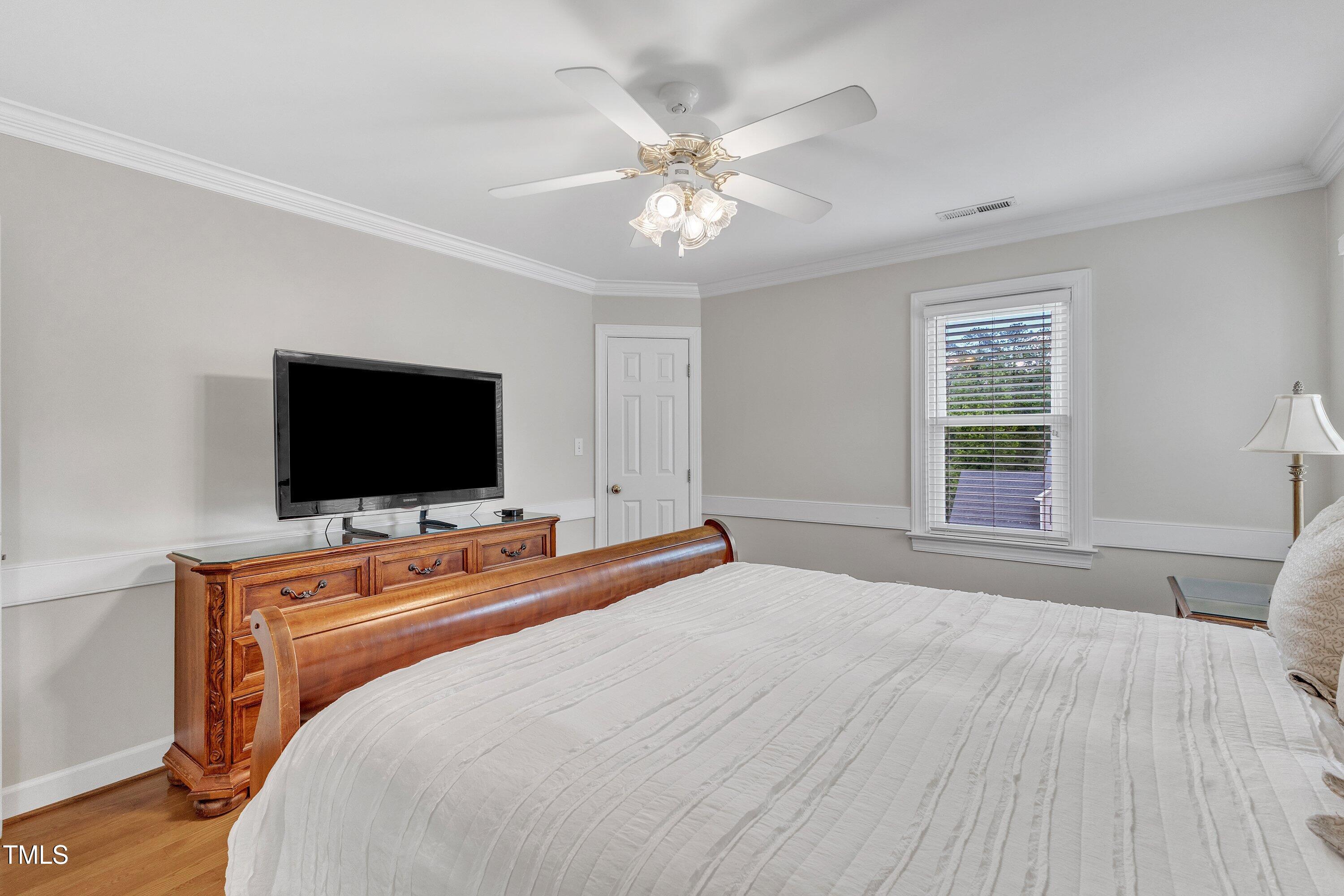 2721 Dahlgreen Road Raleigh, NC 27615 - Photo 28 of 59 a bedroom with a bed and a flat screen tv