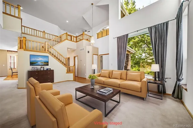 a living room with furniture a fireplace and a large window