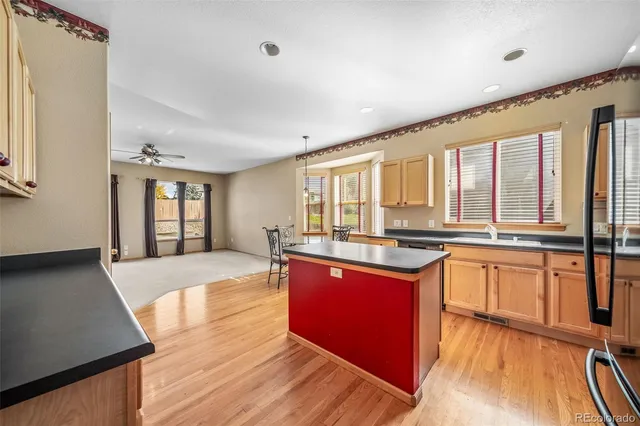 a large kitchen with stainless steel appliances granite countertop a stove and wooden cabinets