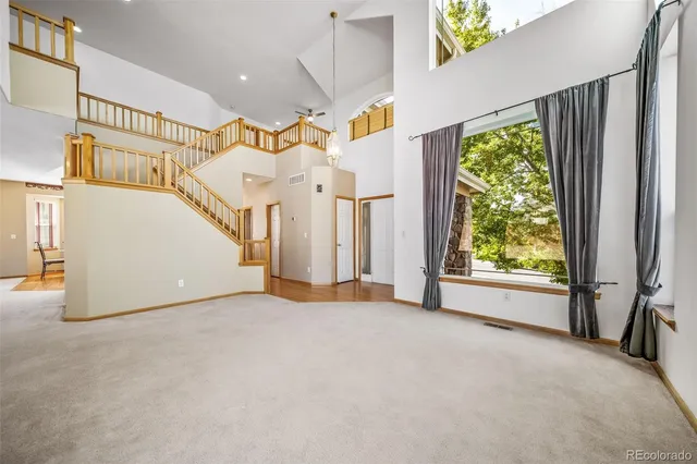 a view of a room with a floor to ceiling window and stairs