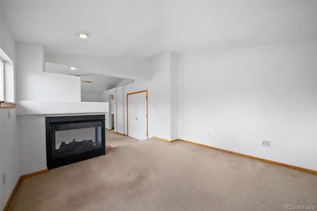 a view of an empty room with a fireplace