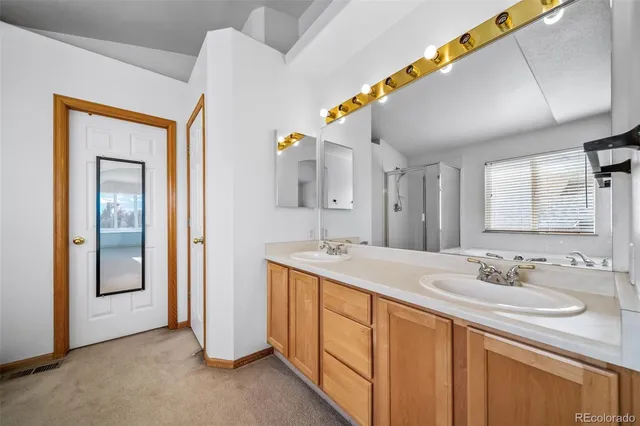 a spacious bathroom with a double vanity sink and a mirror