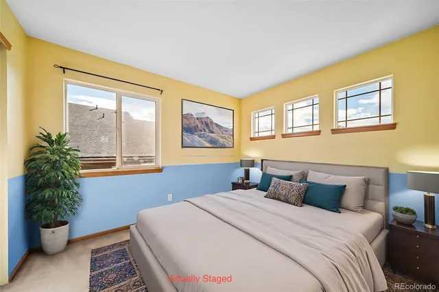 a bedroom with a bed and a potted plant