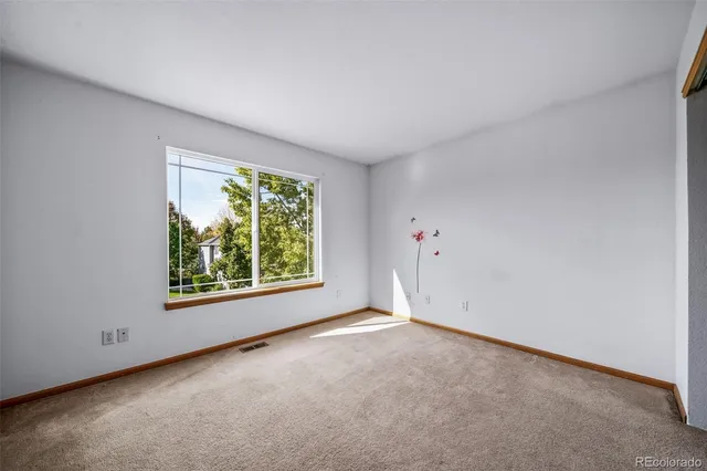 an empty room with windows and yard