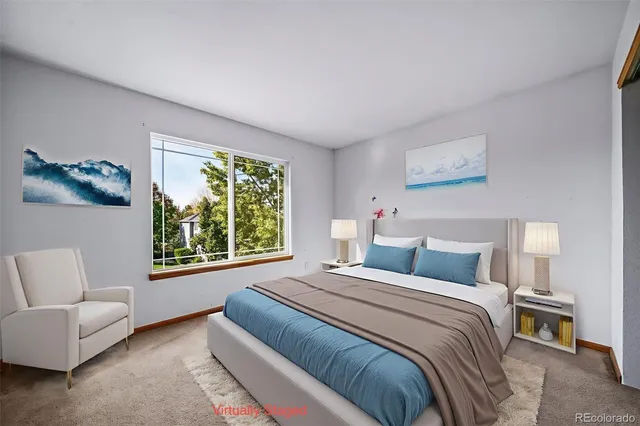 a bedroom with a bed and a couch with window