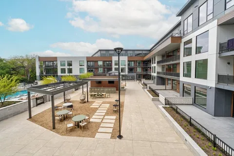 a view of a patio with couches table and chairs with wooden floor