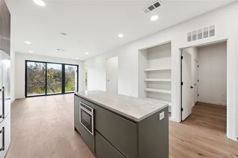 a kitchen with a wooden floor and window