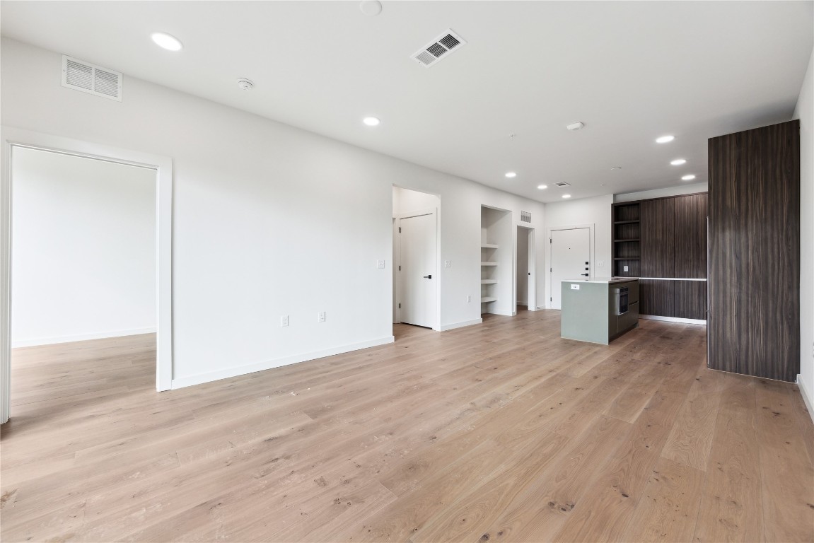 2209 South 1st Street, Unit 226 Austin, TX 78704 - Photo 5 of 27 an empty room with wooden floor and windows