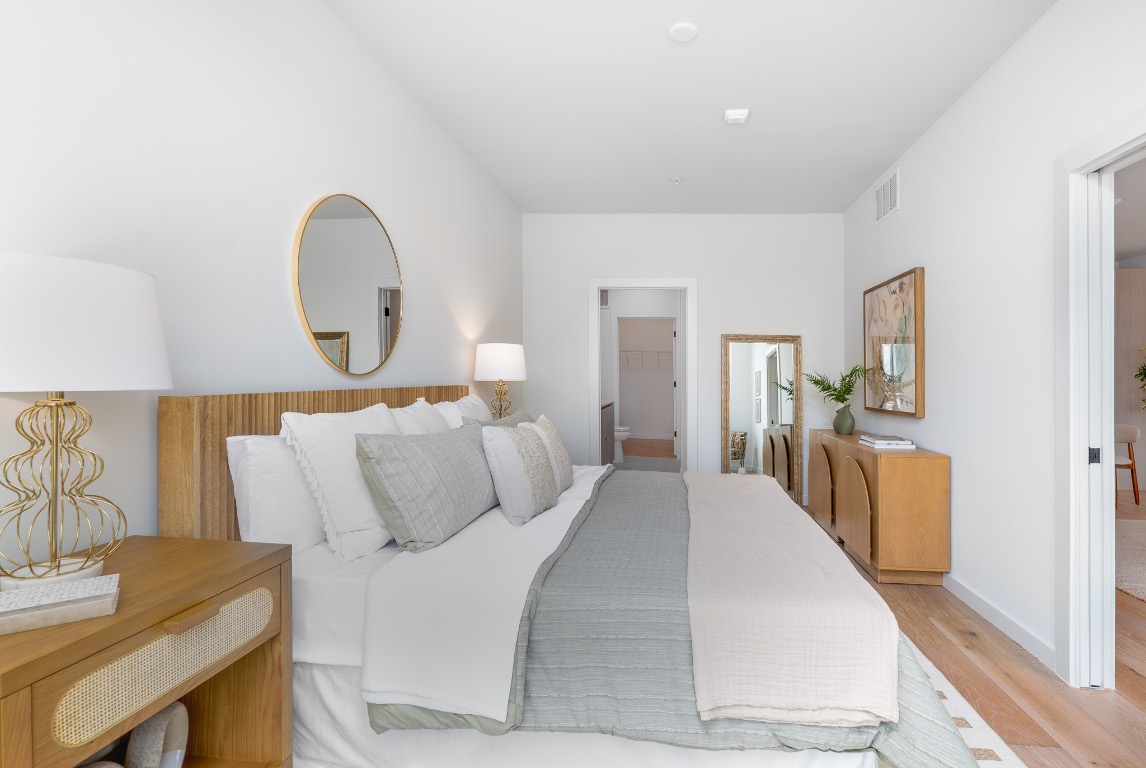 2209 South 1st Street, Unit 226 Austin, TX 78704 - Photo 6 of 27 a bedroom with a bed and wooden floor