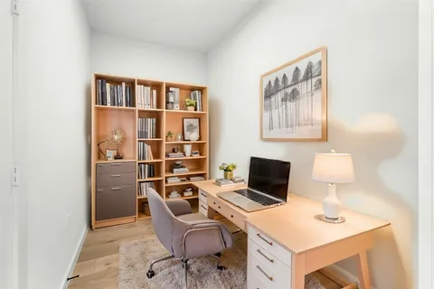 a view of a workspace with furniture