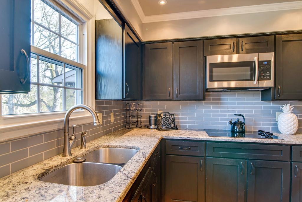 113 Shiloh Ridge Hendersonville, TN 37075 - Photo 12 of 30 a kitchen with a sink a microwave cabinets and a window