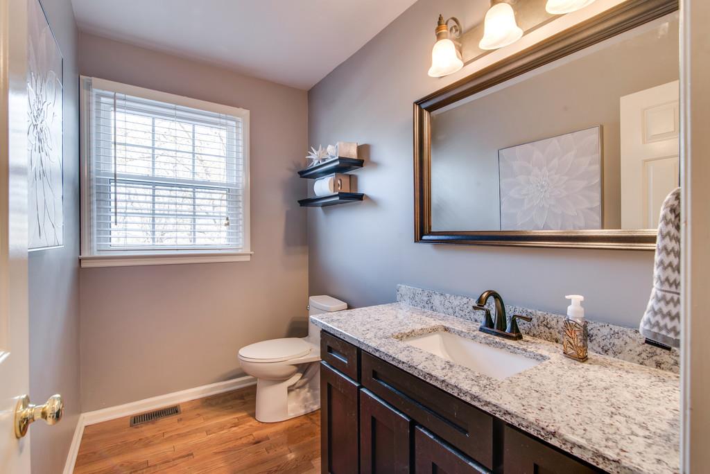 113 Shiloh Ridge Hendersonville, TN 37075 - Photo 18 of 30 a bathroom with a granite countertop sink a toilet and a window